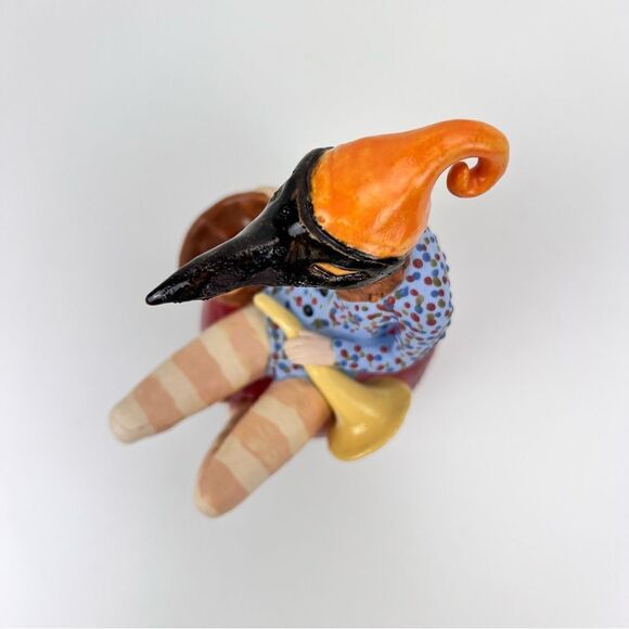 CARRIANNE L HENDRICKSON woman with beak hat sitting on apple sculpture 2… - Picture 8 of 16